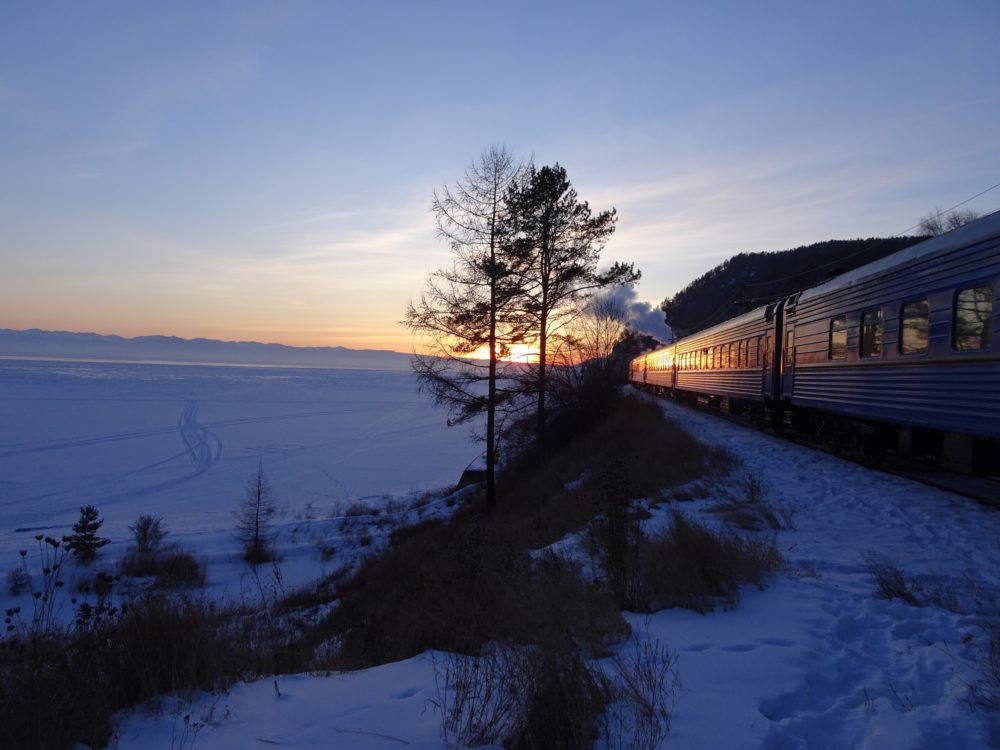 A sunset at Lake Baikal with a steam engine